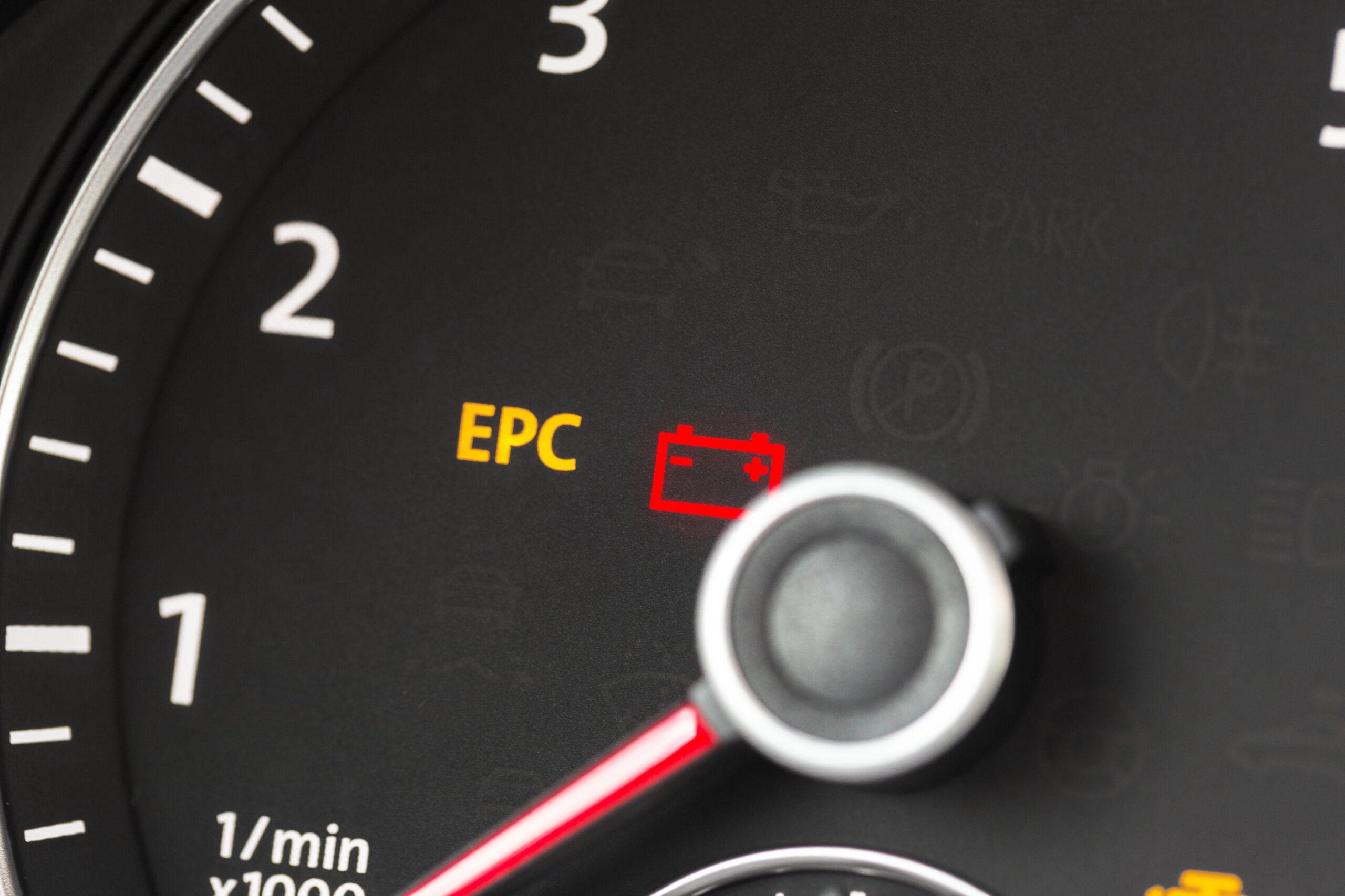 Car dashboard with a red battery warning light and yellow EPC indicator illuminated.